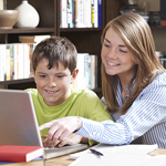 Women and Boy Looking At Computer